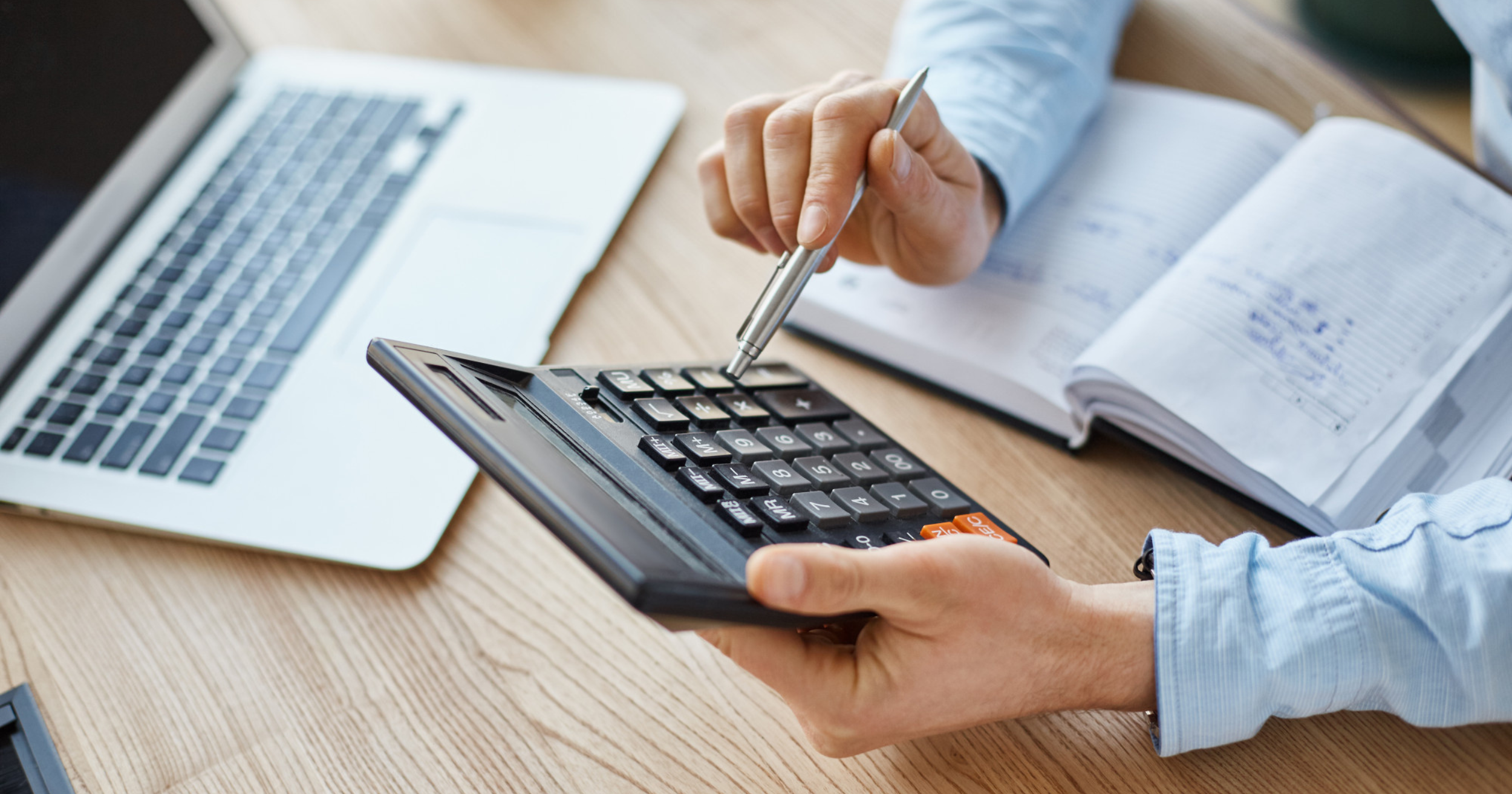 person holding a calculator to estimate taxes
